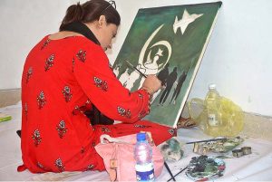 Student Painter giving final touch to her artwork on the upcoming occasion of Defence Day at Arts Council Alhamra Art Gallery