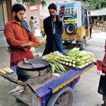 Daily wager preparing popcorn for customers on roadside in the city