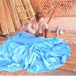 A worker preparing traditional reed curtain (chick) at his workplace