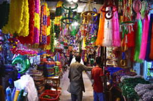 A young vendor displaying the Holly Kaaba model and different kind of decoration stuff at Urdu Bazar in connection with Eid-e-Milad-un-Nabi (SAWW) celebrations.