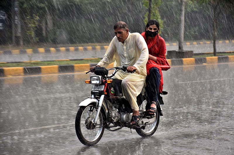 Motorcyclist on the way during heavy rain that experienced in the Provincial Capital