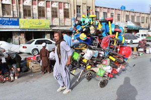 A worker supplying kids cycles to shops at Shahra-e-Iqbal