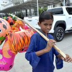 A child selling plastic toys at paris road for livelihood