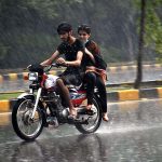Motorcyclist on the way during heavy rain that experienced in the Provincial Capital
