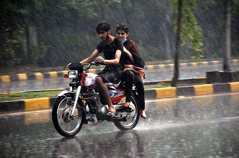 Motorcyclist on the way during heavy rain that experienced in the Provincial Capital