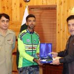 Famous Cyclist and traveler Saqib Rehman presenting National flag and shield to Governor Gilgit-Baltistan Syed Mehdi Shah at Governor House