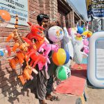 A vendor displaying toys to attract the customers at Chandka Medical College Road.
