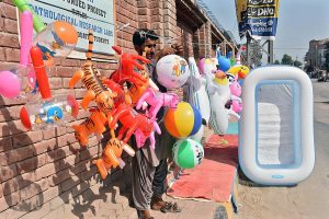 A vendor displaying toys to attract the customers at Chandka Medical College Road. 