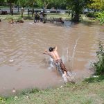 Children are taking a dip in the canal to alleviate the sweltering heat
