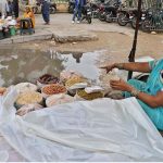 Dry fruit Seller woman is facing a problem due to accumulated water in front of her stall after Light Rain at Empress Market area in the Provincial Capital