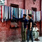 A vendor displaying and selling the dress ties to the customers on the wall of Haji camp at Landa bazar in the Provincial Capital