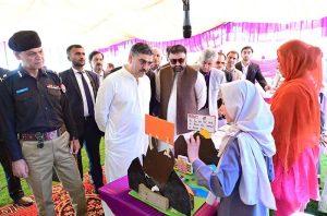 Caretaker Prime Minister Anwaar-ul-Haq Kakar interacts with school students at the display stalls of various science, technology and artistic projects at Chief Minister Secretariat