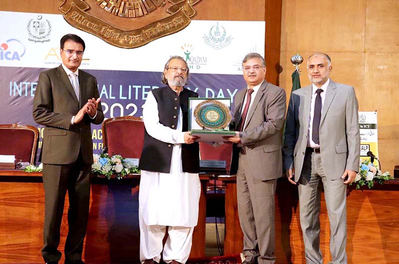 Vice Chancellor Allama Iqbal Open University Professor Dr. Nasir Mahmood presents a souvenir to Caretaker Federal Minister for Education and Professional Training, Madad Ali Sindhi on "Literacy Day"