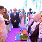 Caretaker Prime Minister Anwaar-ul-Haq Kakar interacts with school students at the display stalls of various science, technology and artistic projects at Chief Minister Secretariat