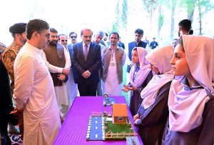 Caretaker Prime Minister Anwaar-ul-Haq Kakar interacts with school students at the display stalls of various science, technology and artistic projects at Chief Minister Secretariat
