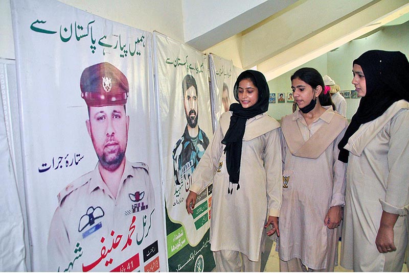 Students are viewing photo exhibition of martyrs on occasion of Defence Day held at Sargodha Arts Council