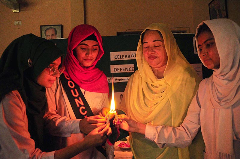 Students are viewing photo exhibition of martyrs on occasion of Defence Day held at Sargodha Arts Council