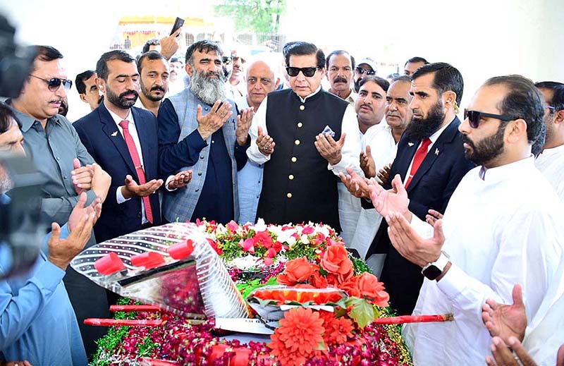 Speaker National Assembly Raja Pervez Ashraf offering Fateha at the grave of Captain Raja Muhammad Sarwar Shaheed Nishan-e-Haider in-connection with Defence Day in Singhori Village