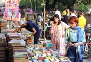People busy in selecting and purchasing old books from roadside setup in Provincial Capital