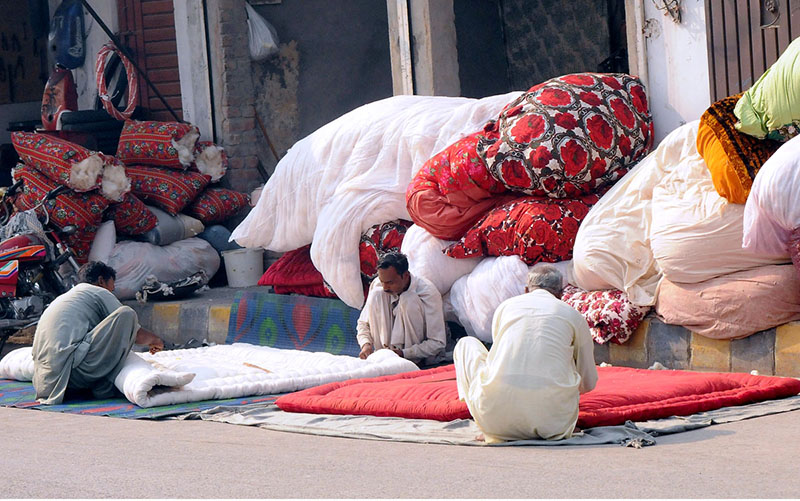 Workers are busy stitching quilts at their workplace as demand increases in winter season