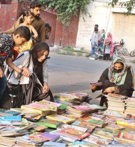 People busy in selecting and purchasing old books from roadside setup in Provincial Capital