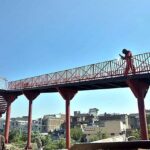 A labourer busy in welding the grills of newly installed pedestrian bridge at IJP Road.