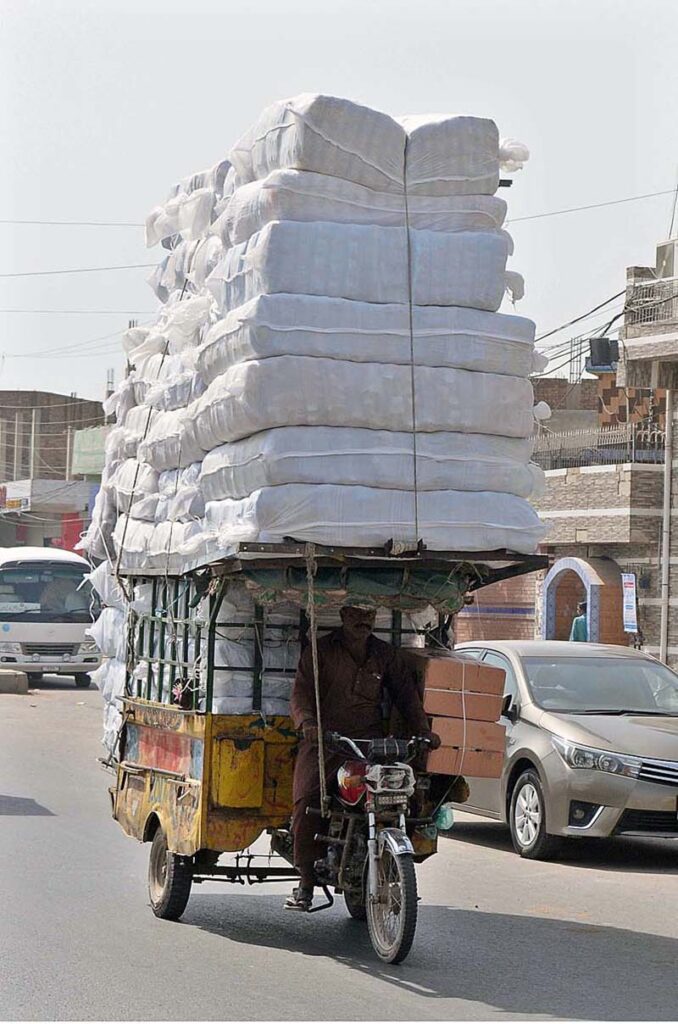 A tricycle rickshaw on the way overloaded with luggage