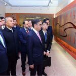 Caretaker Prime Minister Anwaar-ul-Haq Kakar is being briefed on the history of 99 year old Xinjiang University.