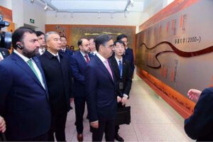 Caretaker Prime Minister Anwaar-ul-Haq Kakar is being briefed on the history of 99 year old Xinjiang University. 