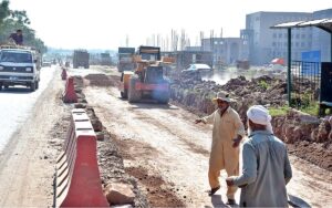 Labourers busy in extension work of Chak Shahzad Road during development work in Federal Capital