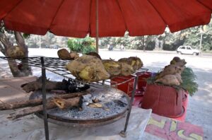 A vendor displaying sweet potatoes to attract customers at his set up at Chak Shahzad neighbourhood in the Federal Capital