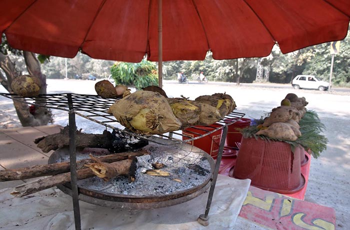 A vendor displaying sweet potatoes to attract customers at his set up at Chak Shahzad neighbourhood in the Federal Capital