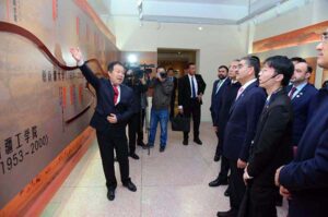 Caretaker Prime Minister Anwaar-ul-Haq Kakar is being briefed on the history of 99 year old Xinjiang University.