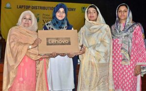Additional Deputy Commissioner Kiran Shehzadi distributing laptops among students under the PM's Youth Laptop Scheme at the Women's University.