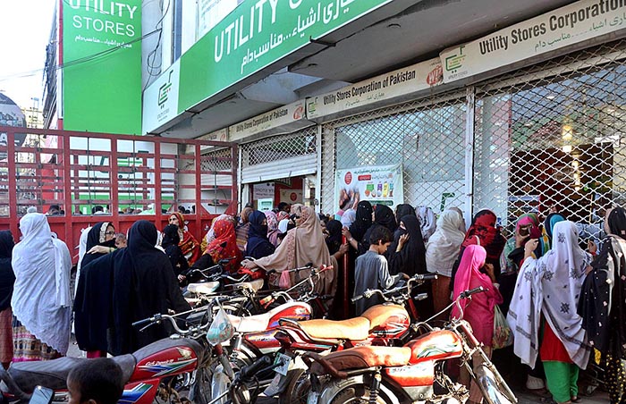 A large number of women standing in a queue waiting their turn outside Utility Store to purchase grocery items at Rasheedabad.
