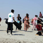 Students cleaning bank of Indus River after seminar on ‘water is life water is food’ during World Food Day organized by Food and Agriculture organization of United Nation.