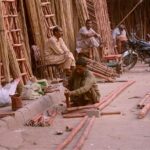 Workers busy in preparing bamboo ladders at his workplace.