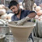 A craftsman preparing clay-made basket at his workplace in Kumharpara.