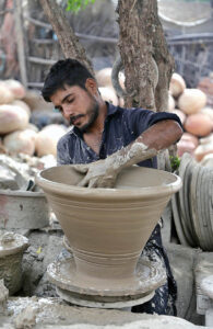 A craftsman preparing clay-made basket at his workplace in Kumharpara. 
