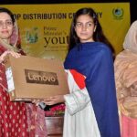 Additional Deputy Commissioner Kiran Shehzadi distributing laptops among students under the PM's Youth Laptop Scheme at the Women's University.