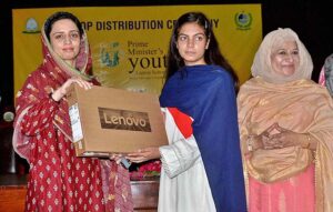 Additional Deputy Commissioner Kiran Shehzadi distributing laptops among students under the PM's Youth Laptop Scheme at the Women's University. 