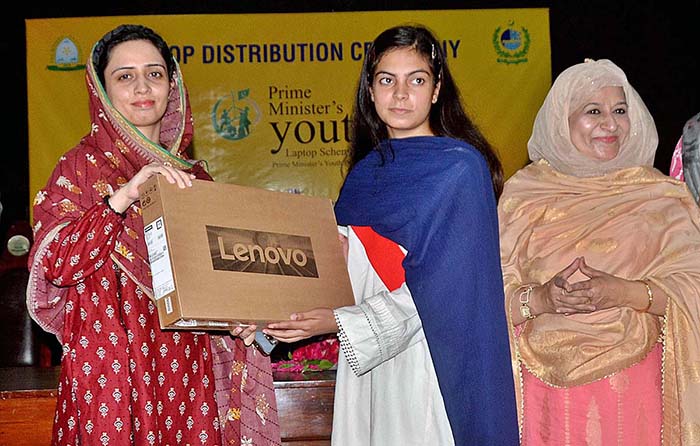 Additional Deputy Commissioner Kiran Shehzadi distributing laptops among students under the PM's Youth Laptop Scheme at the Women's University.