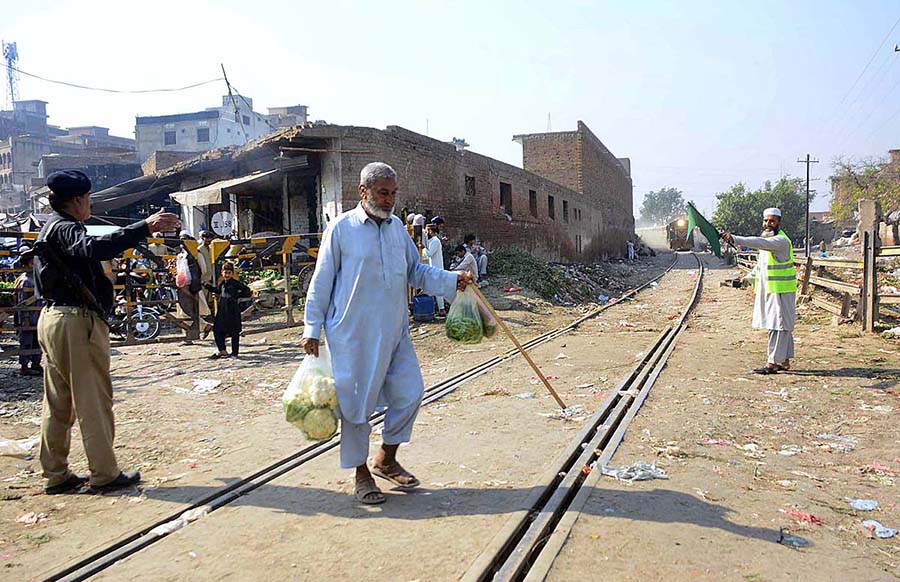 An elderly person crossing railway track while a train approaching may cause any mishap and needs the attention of concerned authorities at Sabzi Mandi