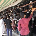 People busy in selecting and purchasing second hand shoes from vendors at weekly Sunday Bazaar, Peshawar Morr
