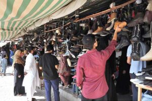 People busy in selecting and purchasing second hand shoes from vendors at weekly Sunday Bazaar, Peshawar Morr