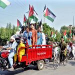 People participating in a rally to show solidarity with Palestine at Abdali Road.