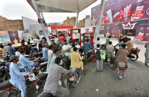 A large number of motorcyclists at petrol pump after the government reduce the petrol prices.