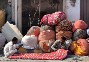 Workers are busy stitching quilts for the upcoming winter season at their workplace