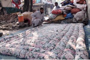 Worker busy in preparing quilt for upcoming winter season at their workplace as the demand of warm goods increased after the temperature dropping rapidly in the city.