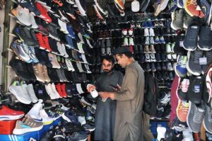 People busy in selecting and purchasing second hand shoes from vendors at weekly Sunday Bazaar, Peshawar Morr